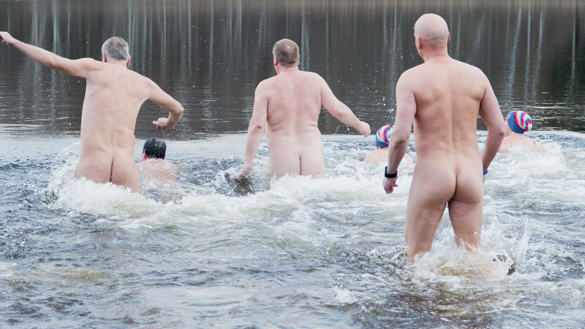 Nackte Schwimmer laufen beim Neujahrs-Nackt-Schwimmen in den Sonnensee in Hannover. Auch in Köln gibt es eine große FKK-Szene.