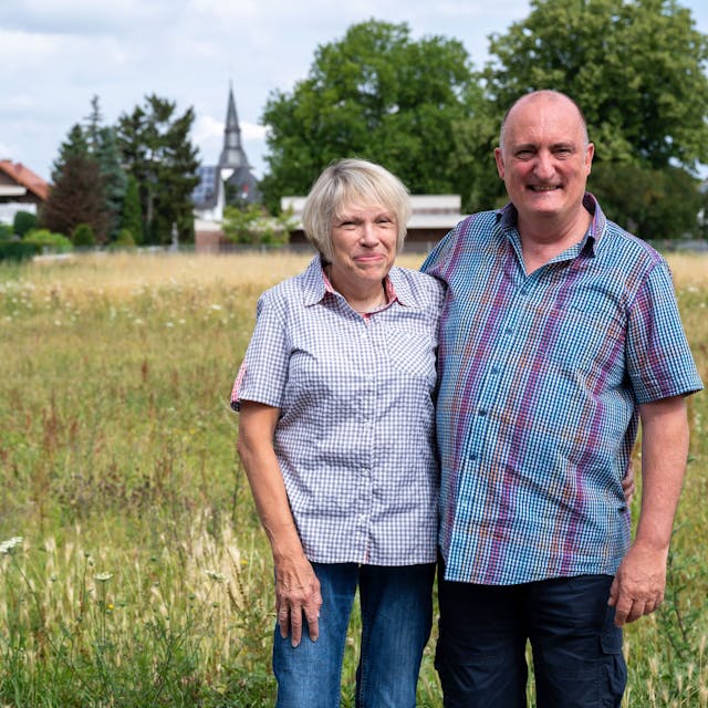 Das Ehepaar Eich steht vor seinem neuen Grundstück in Erftstadt-Erp. Das Haus der beiden ist bei der Flutkatastrophe an der Erft in den Kiesgrubenkrater in Blessem gestürzt.