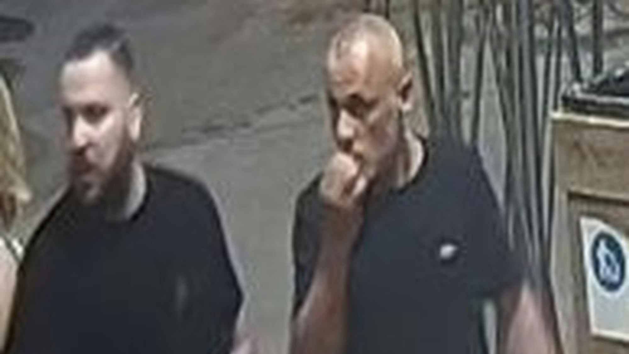 Zwei Männer in komplett schwarzer Kleidung, eingefangen von einer Überwachungskamera.