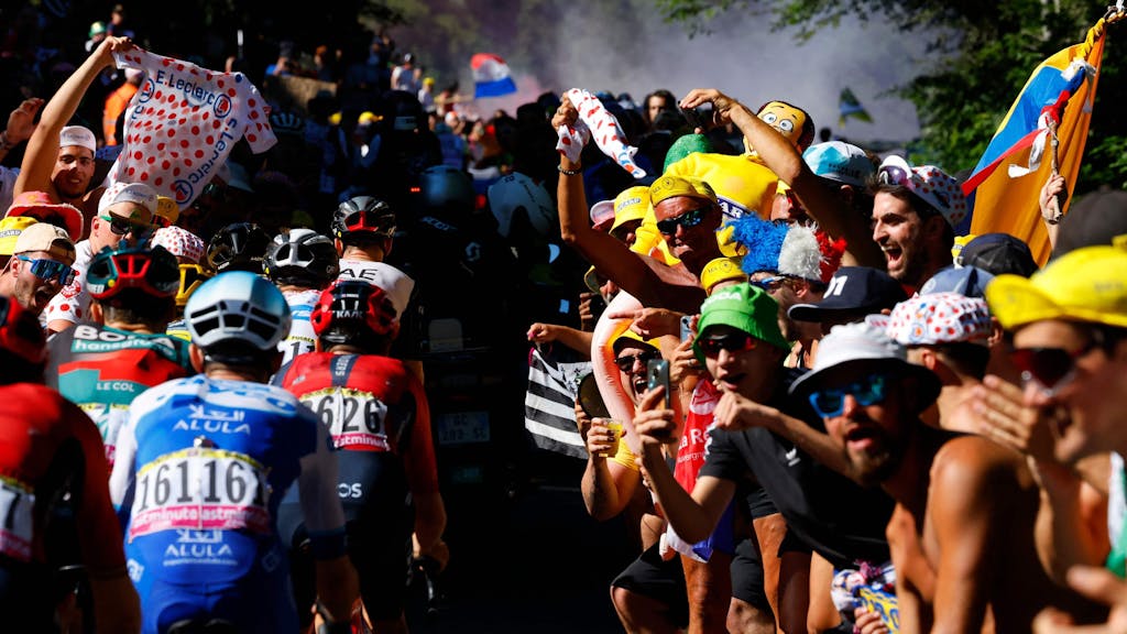 Die Fahrer der Tour de France fahren durch die Fan-Massen.