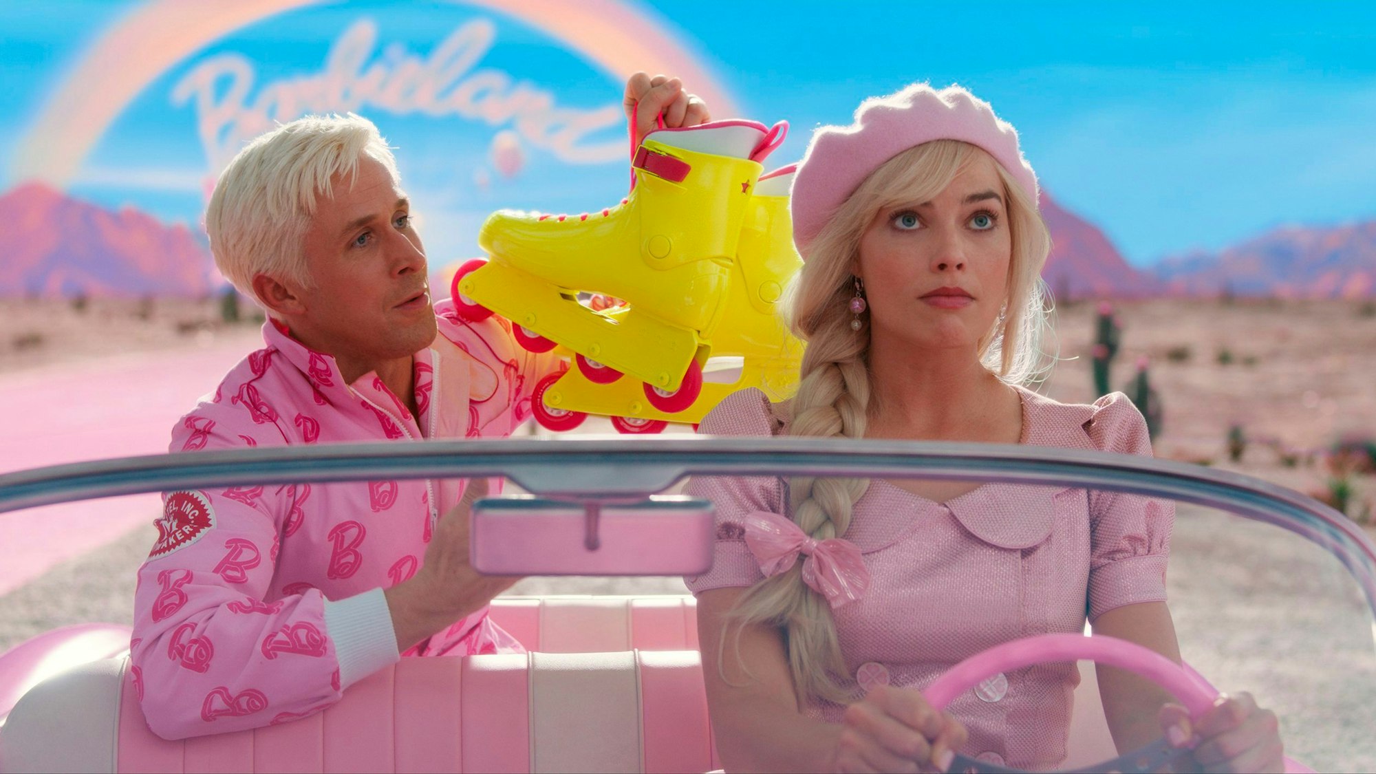 Ryan Gosling als Ken und Margot Robbie als Barbie sitzen in einer pinken Corvette.
