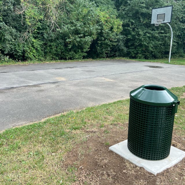 Neben dem Basketballfeld steht nun auch ein grüner Mülleimer.