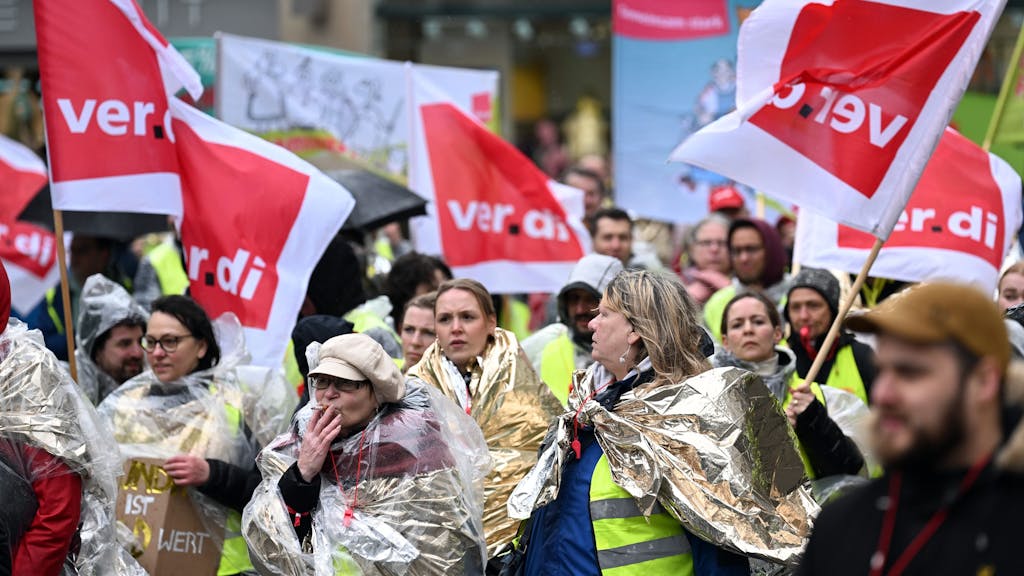 Streikende ziehen mit Verdi-Fahnen und Bannern durch die Düsseldorfer Innenstadt.