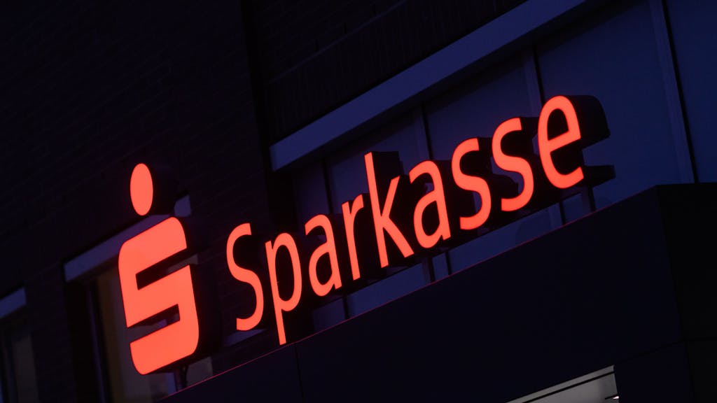 Ein Schriftzug der Sparkasse leuchtet an einer Filiale in der Region Hannover, hier im Januar 2023.