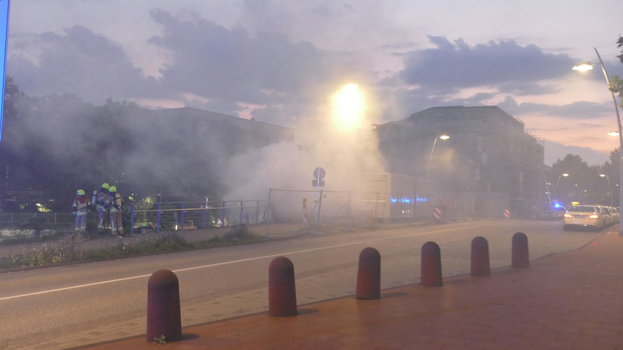 Eine dichte Rauchwolke liegt über einem Bahnhof.