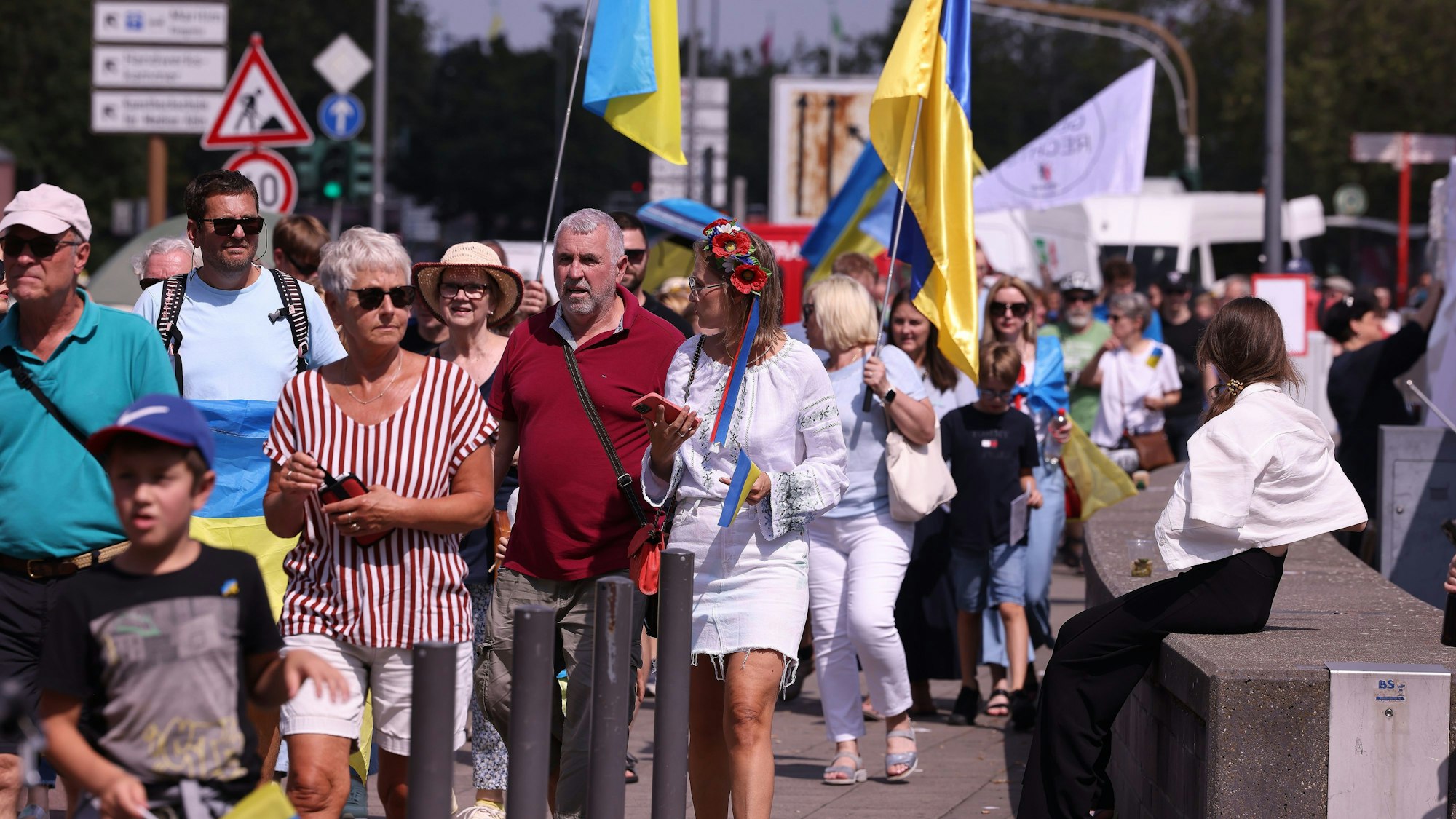 Menschen demonstrieren in Köln gegen den russischen Angriffskrieg. Zum zweiten Mal findet der Ukraine-Tag mit einem Benefizfestival für ukrainische Kunst und Kultur am Rheinufer in Köln statt.