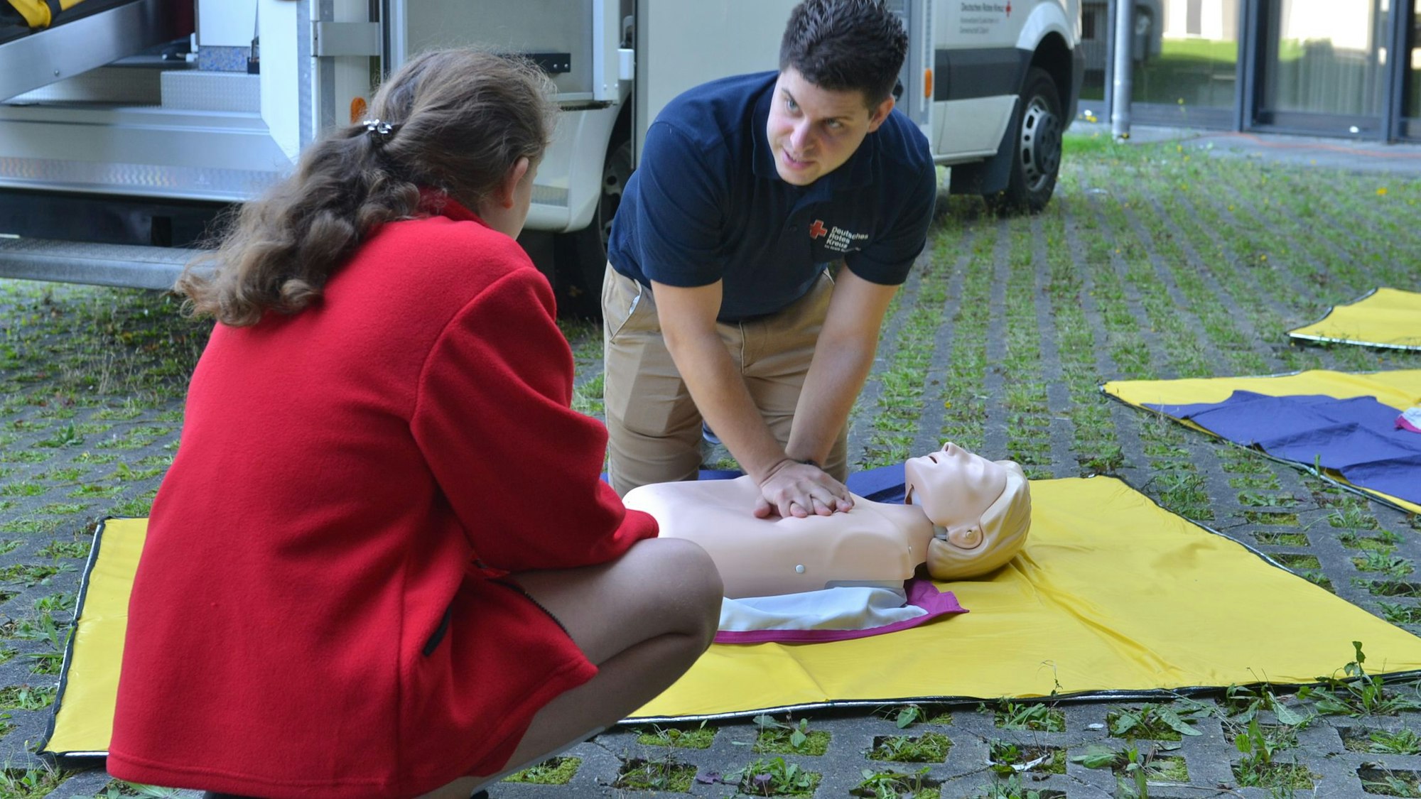Das Bild zeigt eine Situation aus dem Erste-Hilfe-Lehrgang. Ein Mann übt die Herzdruckmassage.