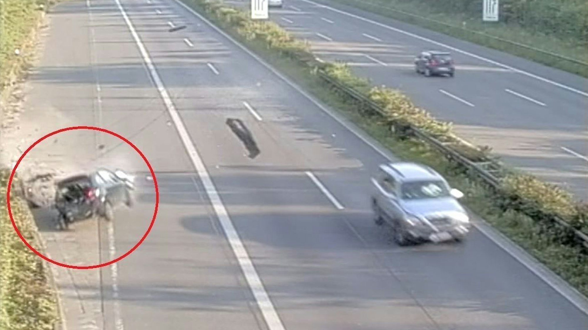 Screenshot aus einem Video, das einen Unfall auf der Autobahn zeigt. Ein schwarzer Peugeot prallt in die Mauer.