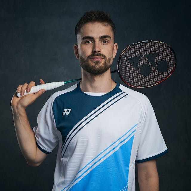 Nationalspieler Jan Colin Völker posiert im Trikot und mit Badmintonschläger