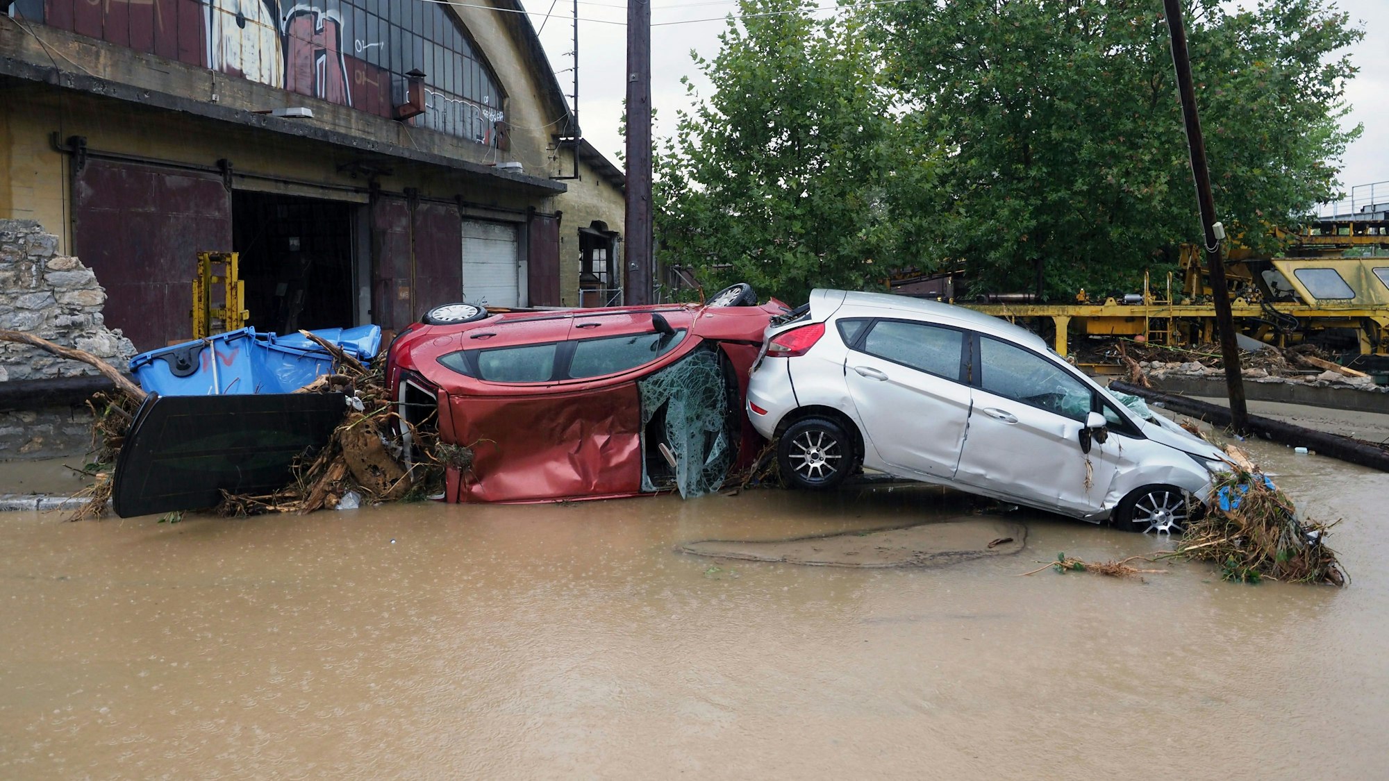 Damaged cars are pilled up on a flooded road after a rainstorm in Volos, central Greece, Wednesday, Sept. 6, 2023. The death toll from severe rainstorms that lashed parts of Greece, Turkey and Bulgaria increased Wednesday after rescue teams located the body of a missing vacation who was swept away by flood waters that raged through a campsite in northwest Turkey. (AP Photo/Thodoris Nikolaou)