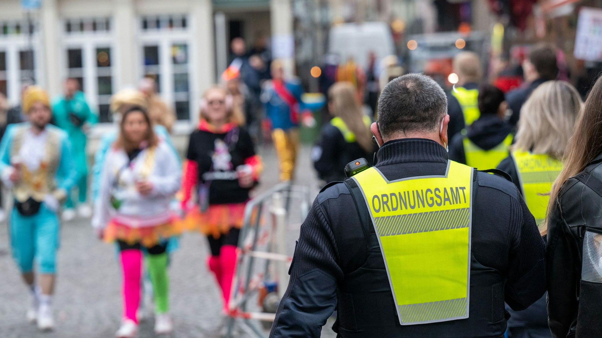 Mitarbeitende des Ordnungsamts auf Streife in der Kölner Altstadt während der Feierlichkeiten zu Karneval.