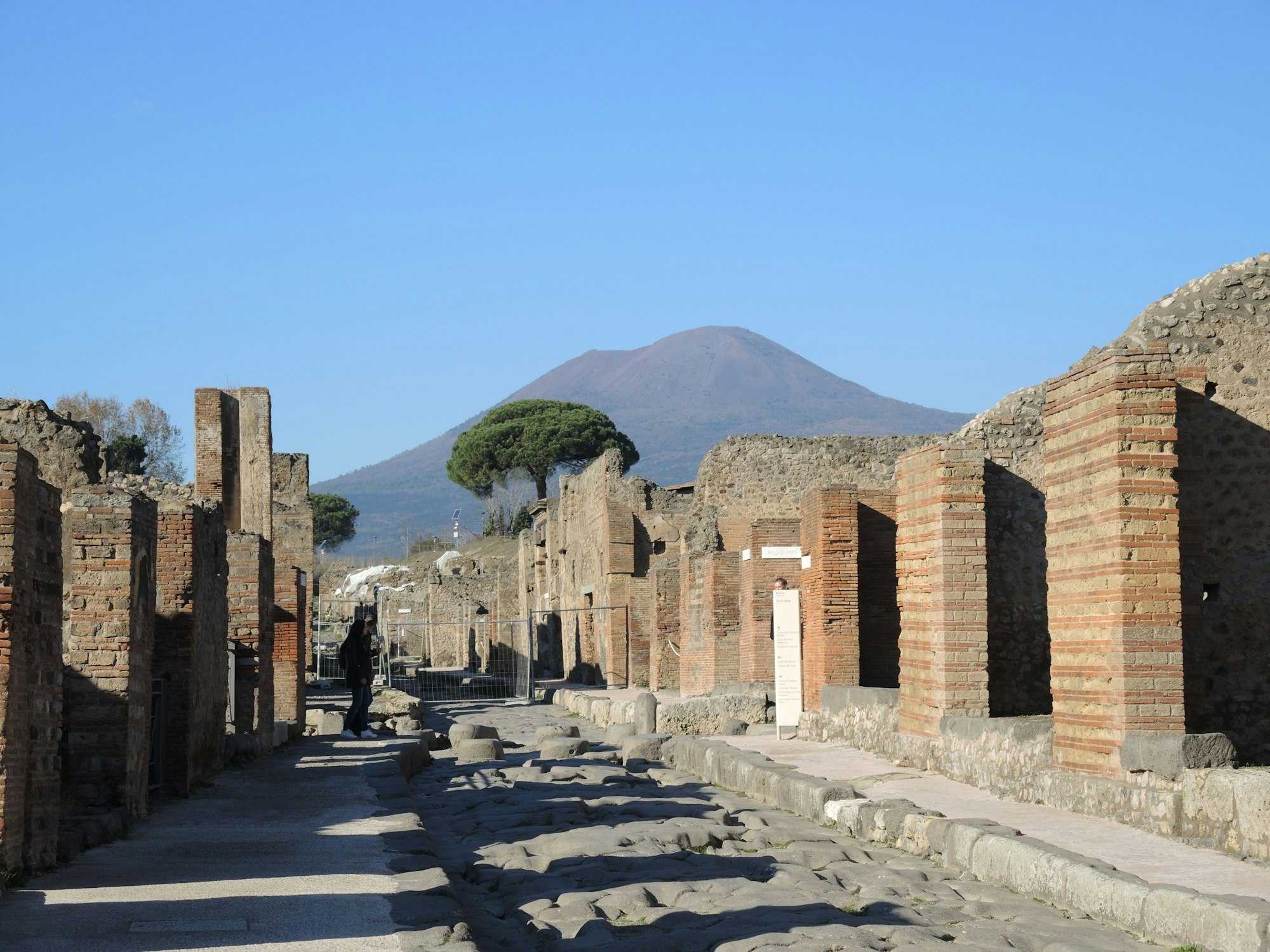 Eine Straße im Archäologischen Park Pompeji mit Blick auf den Vesuv in Italien, hier im November 2018.