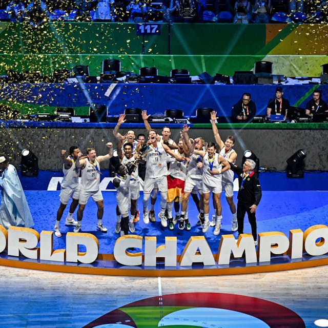 TOPSHOT - Germany's players celebrate with their head coach Gordon Herbert (R) after winning the FIBA Basketball World Cup final game against Serbia in Manila on September 10, 2023. (Photo by SHERWIN VARDELEON / AFP)
