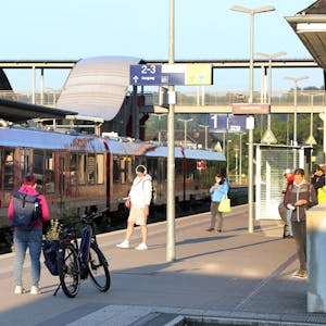 Ein Zug steht im Overather Bahnhof, Fahrgäste stehen auf dem Bahnsteig.