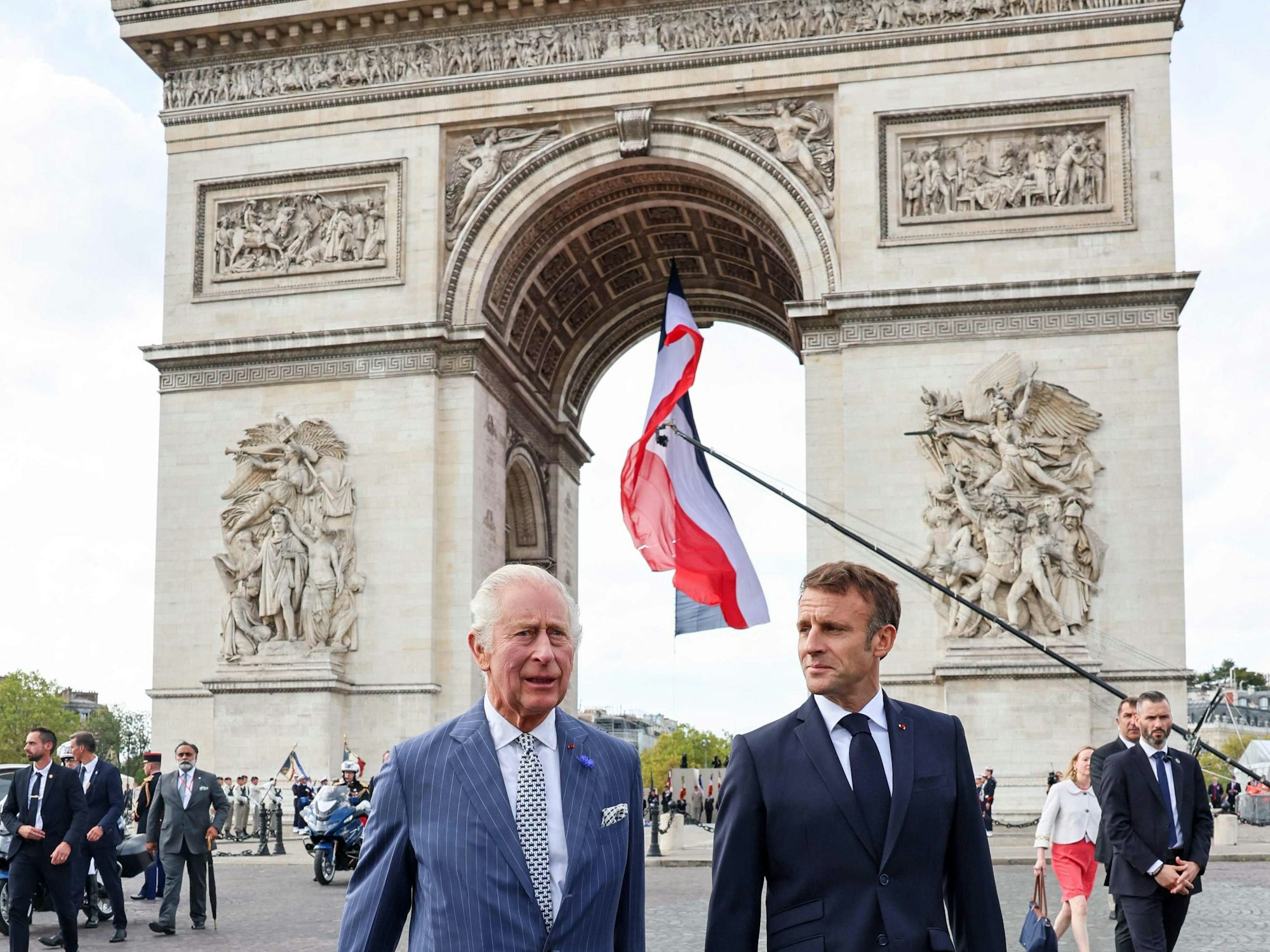 Britain's King Charles III (L) and French President Emmanuel Macron (R) depart the Arc de Triomphe after a wreath-laying ceremony at the Tomb of the Unknown Soldier in Paris on September 20, 2023, on the first day of a state visit to France. Britain's King Charles III and his wife Queen Camilla are on a three-day state visit to France. (Photo by Chris Jackson / POOL / AFP)