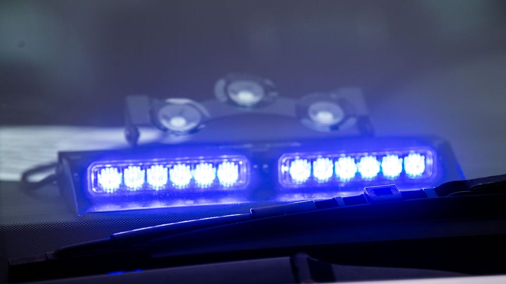Ein Blaulicht ist unter der Frontscheibe eines Einsatzfahrzeugs der Polizei angebracht.