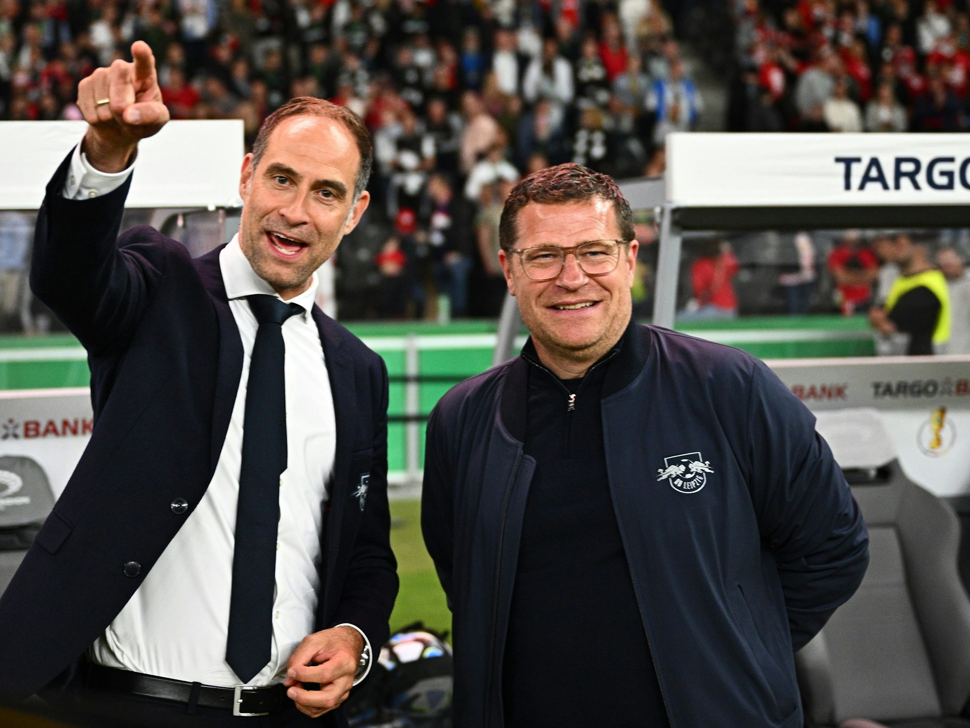 Oliver Mintzlaff und Max Eberl gucken vor dem DFB-Pokalfinale in die Kamera.