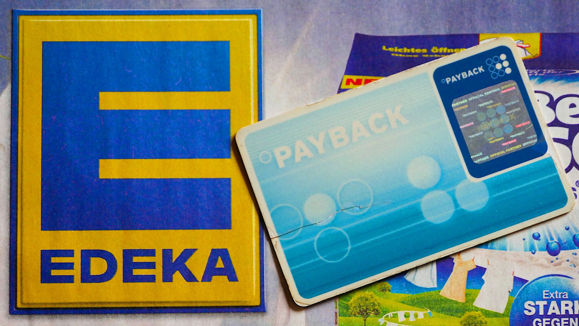 Eine Payback-Karte und das Edeka-Logo sind zu sehen.