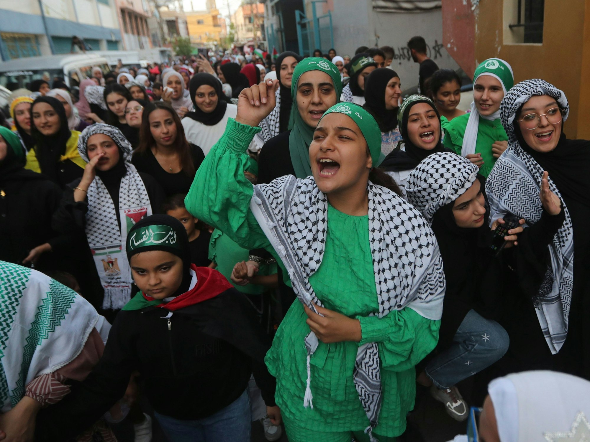 Palestinian shout slogans during a celebration of the attacks that the militant Hamas group carried out against Israel, at al-Bass Palestinian refugee camp, in southern port city of Tyre, Lebanon, Saturday, Oct. 7, 2023. The militant Hamas rulers of the Gaza Strip carried out an unprecedented, multi-front attack on Israel at daybreak Saturday, firing thousands of rockets as dozens of Hamas fighters infiltrated the heavily fortified border in several locations by air, land, and sea and catching the country off-guard on a major holiday. (AP Photo/Mohammed Zaatari)