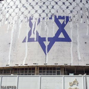 A man rides his motorcycle past an anti-Israel billboard with the chequerred keffiye covering the Star of David, entitled "Operation Al-Aqsa Flood," in solidarity with the Palestinians in Tehran's central Vali-Asr square on October 8, 2023. The Israeli-Palestinian conflict's bloodiest escalation in decades saw Hamas carry out a massive rocket barrage and ground, air and sea operation on October 7 that Israel's army said had killed more than 200 Israelis and wounded 1,000, while soldiers and civilians were taken hostage. (Photo by AFP)