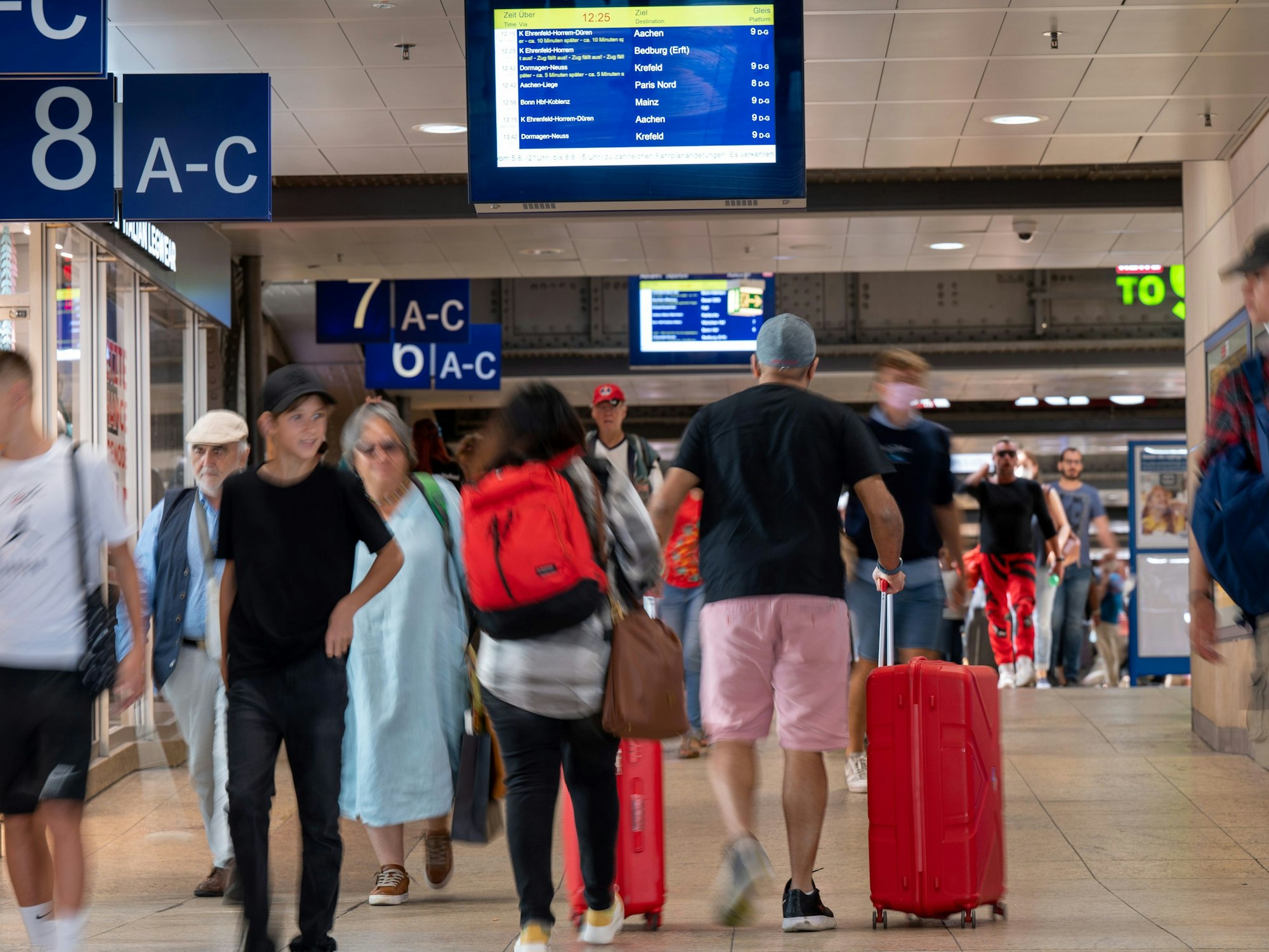 Reisende suchen nach Informationen auf den Anzeigetafeln im Hauptbahnhof