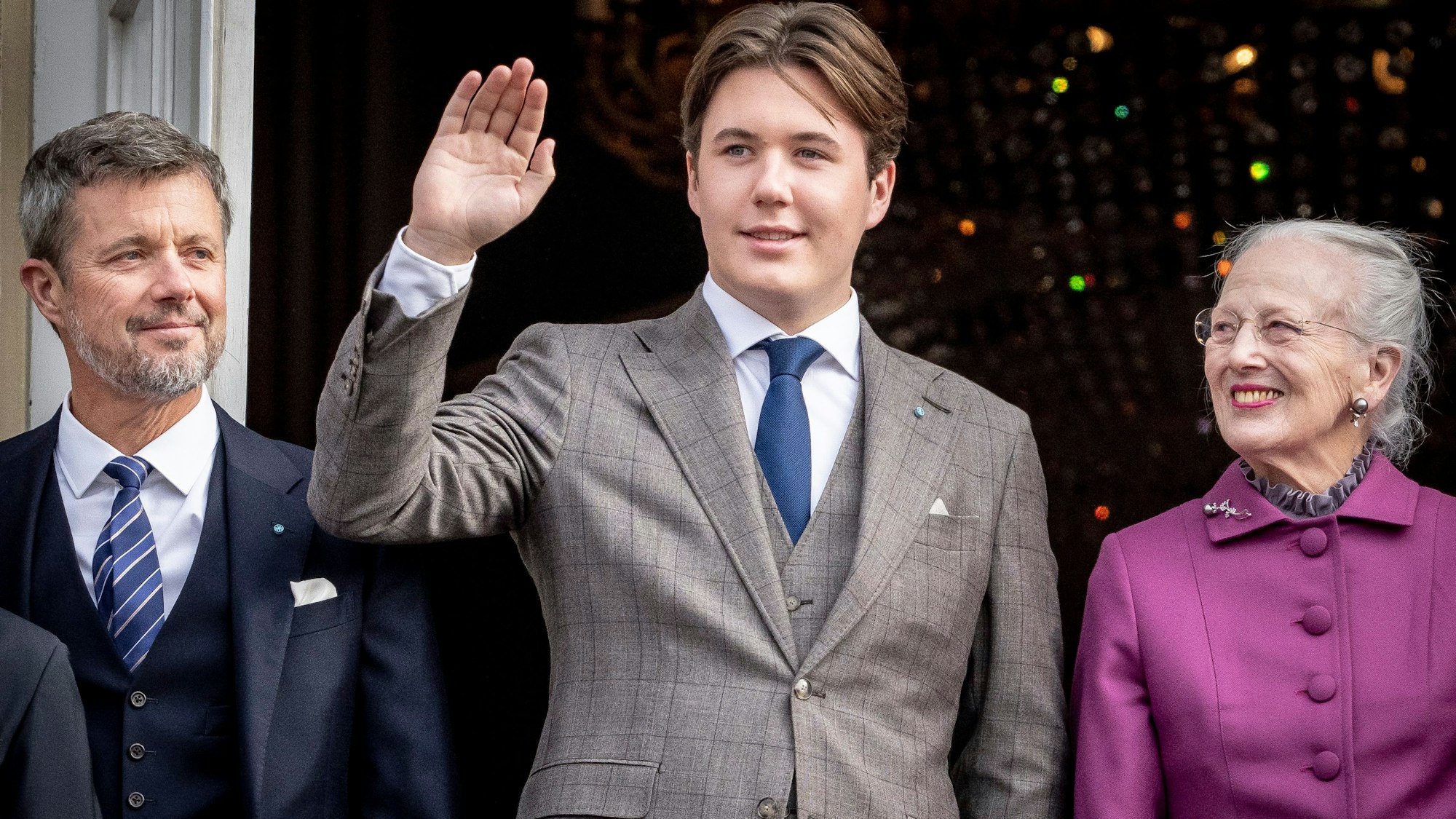 Prinz Christian (M) von Dänemark winkt an seinem 18. Geburtstag am 15. Oktober 2023 auf Schloss Amalienborg in Begleitung von Königin Margrethe II.(r) und Kronprinz Frederik (l) von Dänemärk.