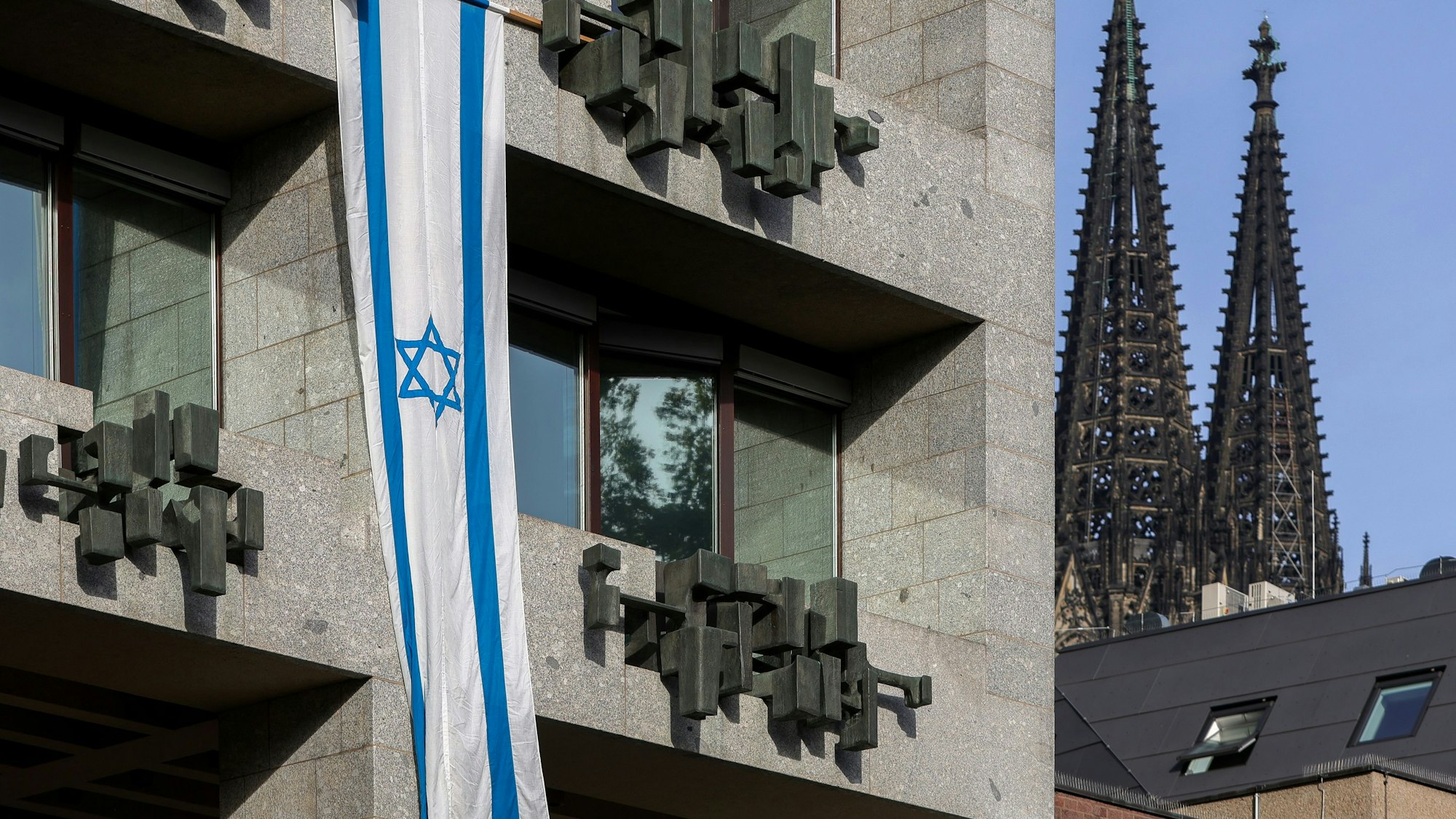 Zu sehen ist eine israelische Flagge an der Fassade des Kölner Rathauses.
