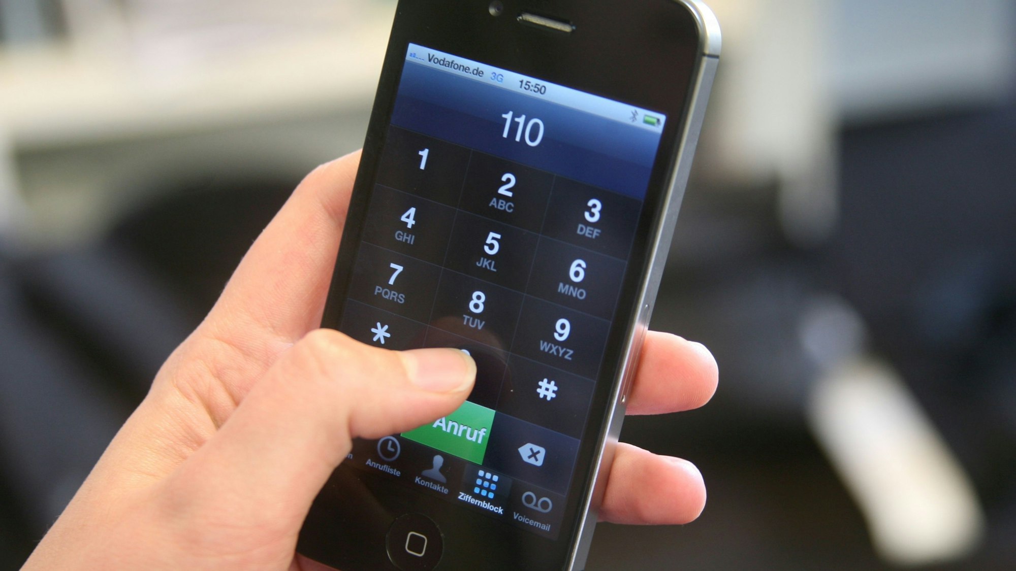 Das Bild zeigt eine Hand, die ein Smartphone festhält und die 110, die Notrufnummer der Polizei, eingetippt hat.
