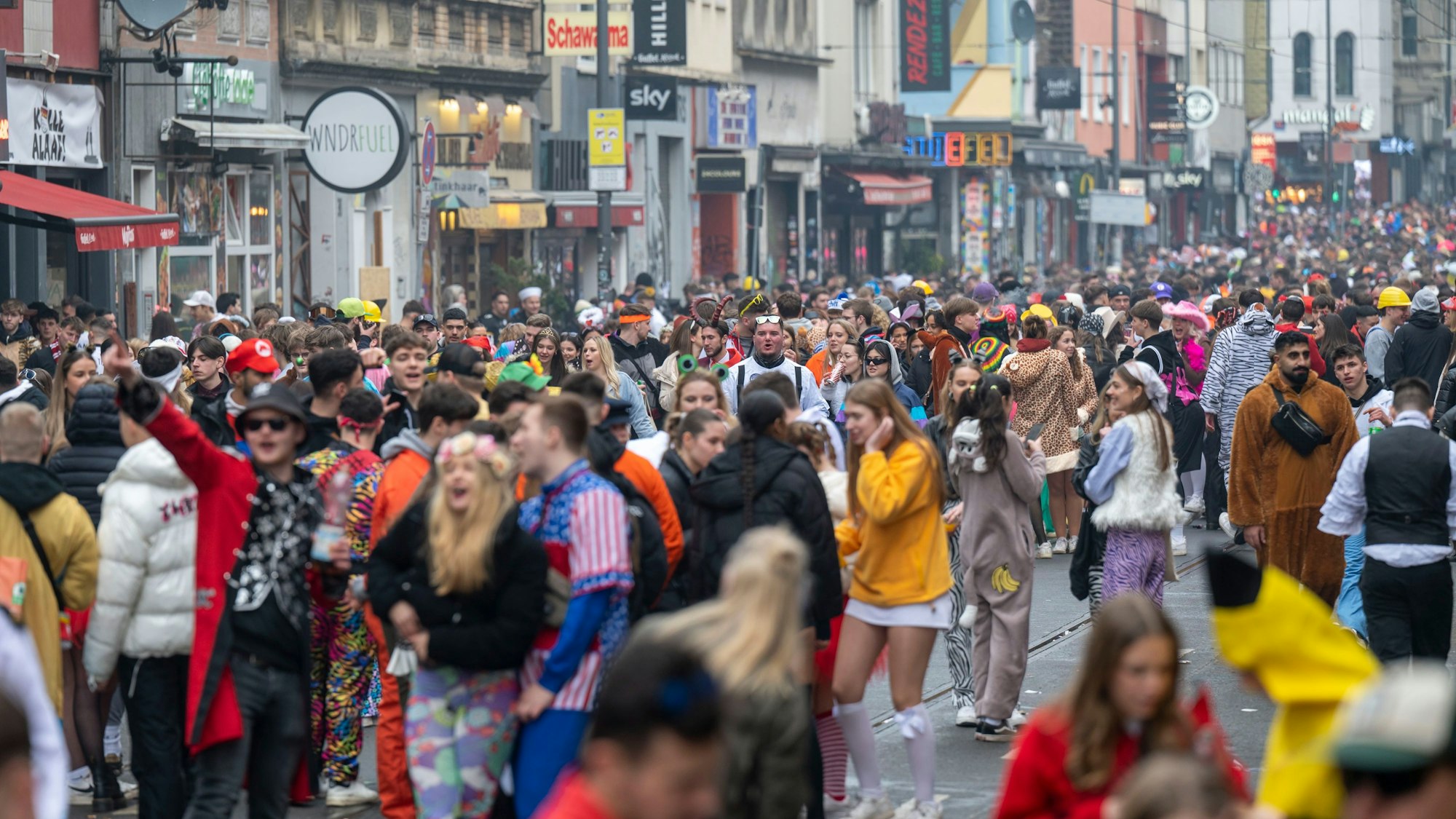 Tausende feiernde Menschen in Kostümen stehen auf der Zülpicher Straße in Köln.
