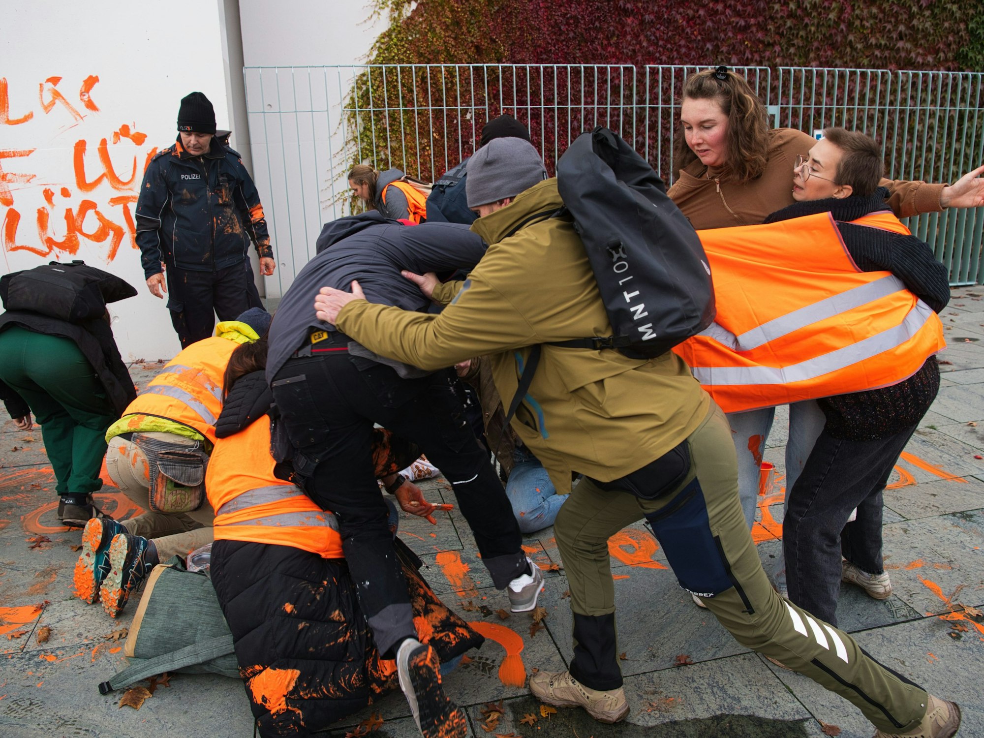Aktivistinnen und Aktivisten der Gruppe Letzte Generation werden vor dem Kanzleramt von Zivilkräften der Polizei gestoppt.
