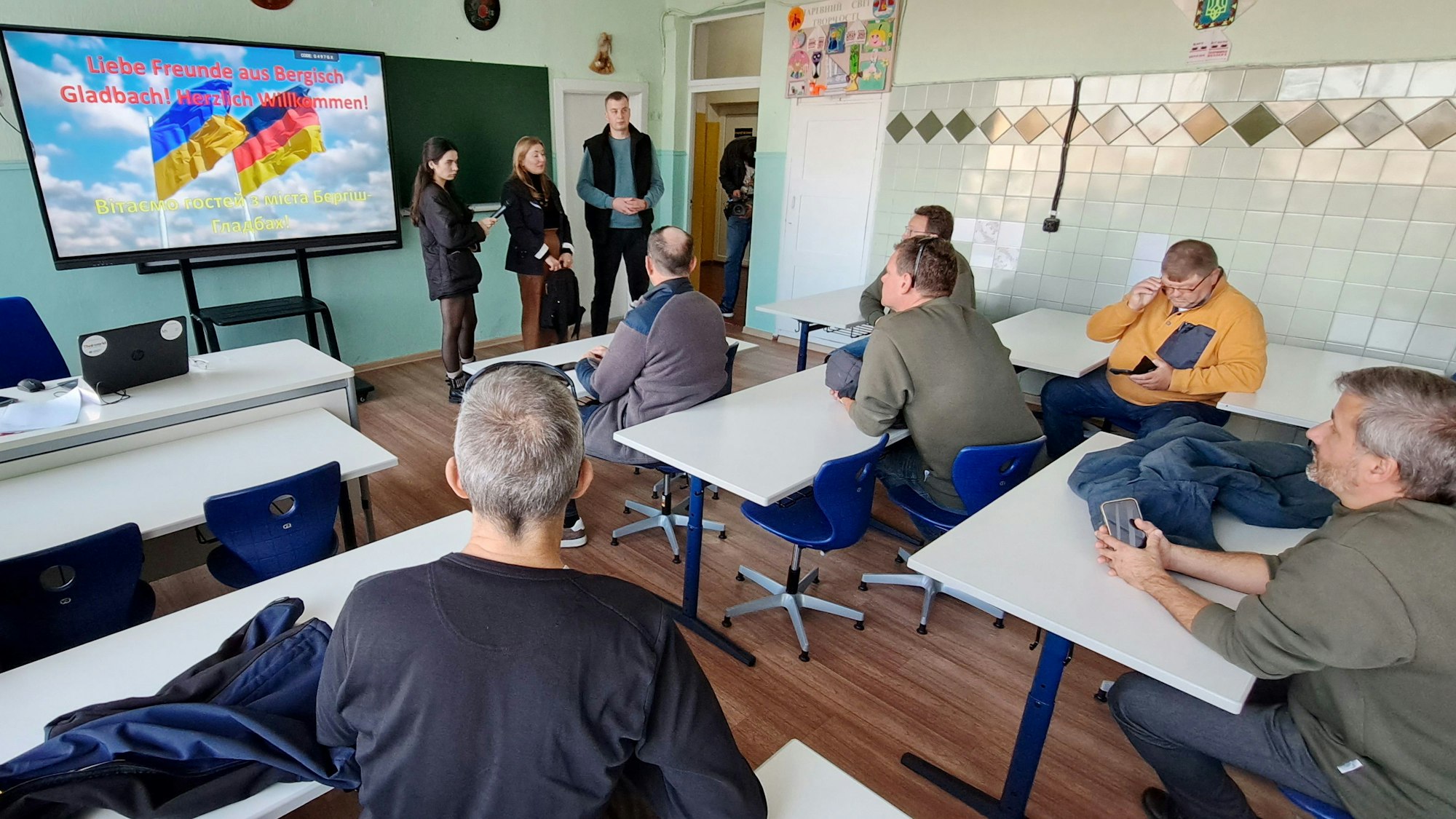 Hilfskonvoifahrer aus Bergisch Gladbach sitzen in einem neu eingerichteten Klassenraum in Butscha.
