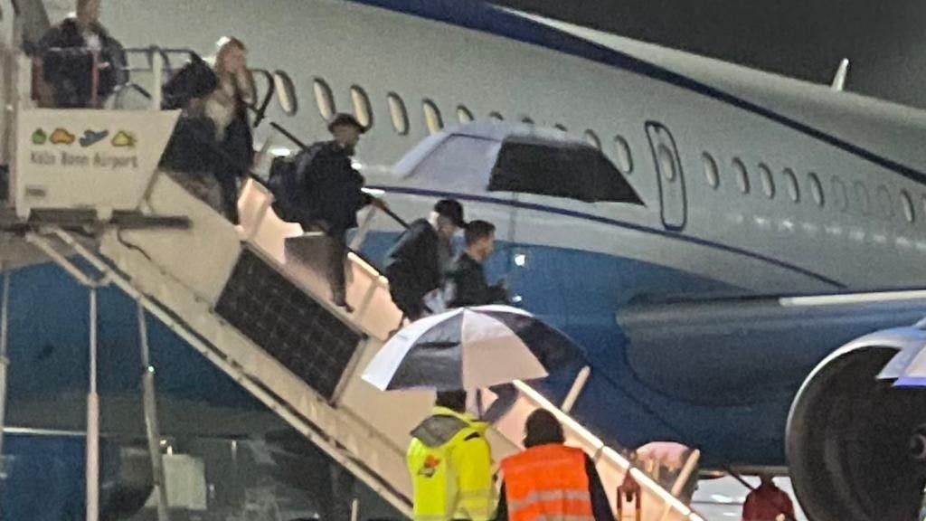 Madonna steigt mit ihrer Crew aus dem Flugzeug aus.
