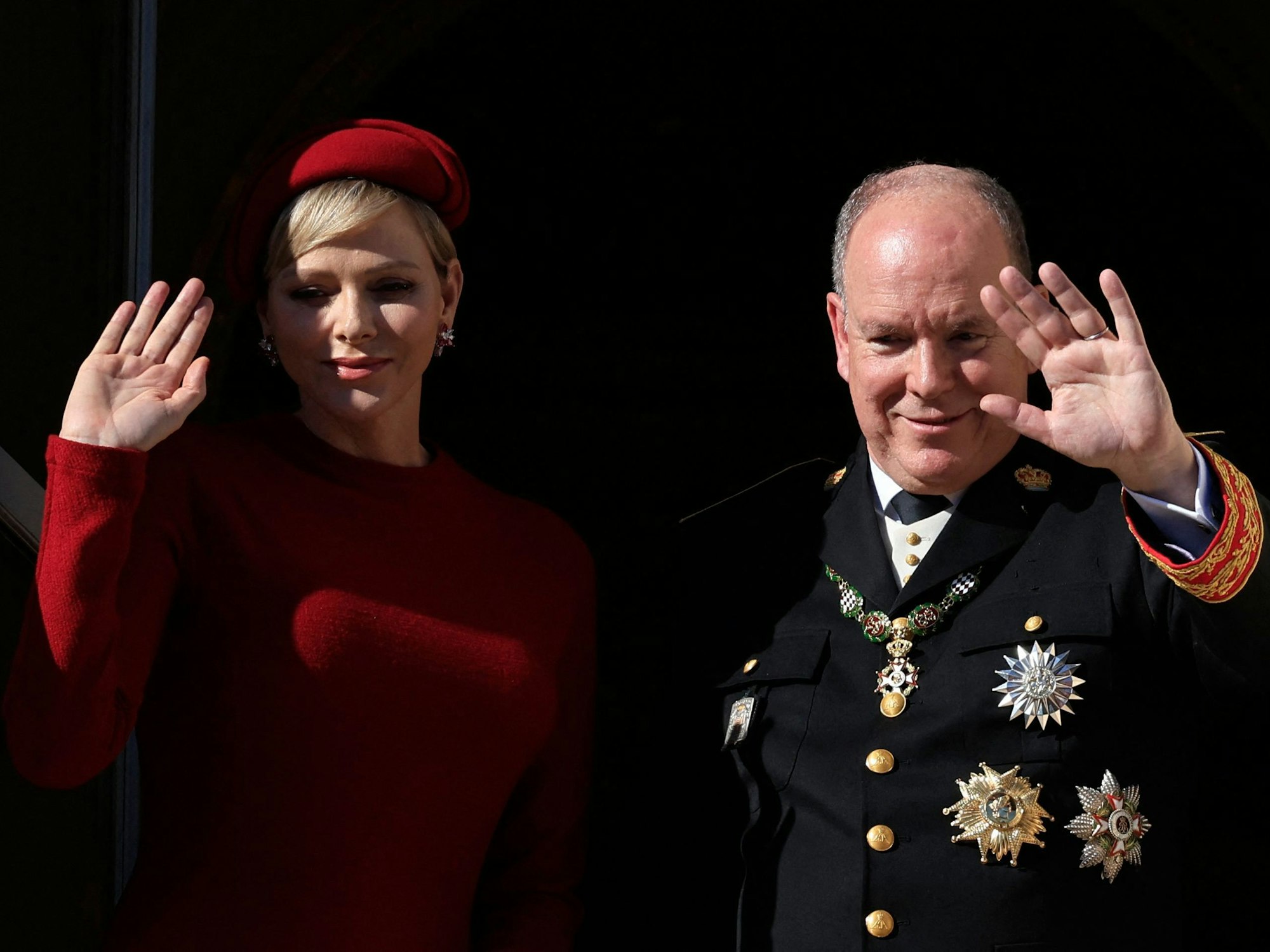 Fürst Albert II. von Monaco (r.) und Fürstin Charlène von Monaco (l.) winken vom Balkon des Fürstenpalastes während einer Zeremonie zum Nationalfeiertag.
