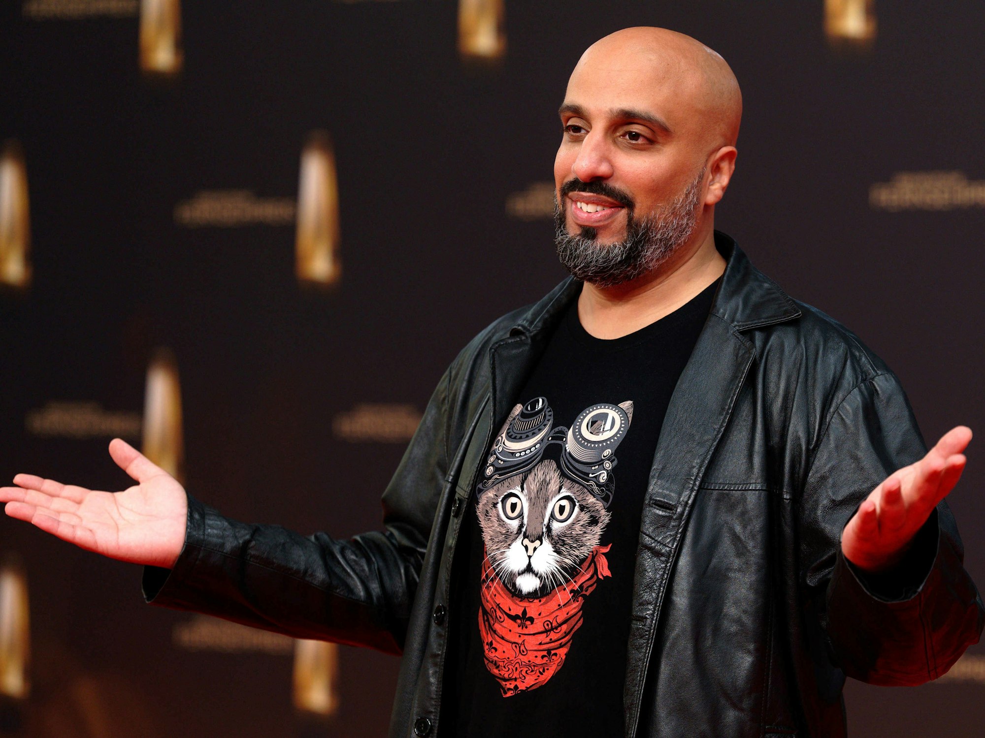 Der Comidian Abdelkarim kommt zur Verleihung vom Deutschen Fernsehpreis 2022 auf die Bühne und grinst.