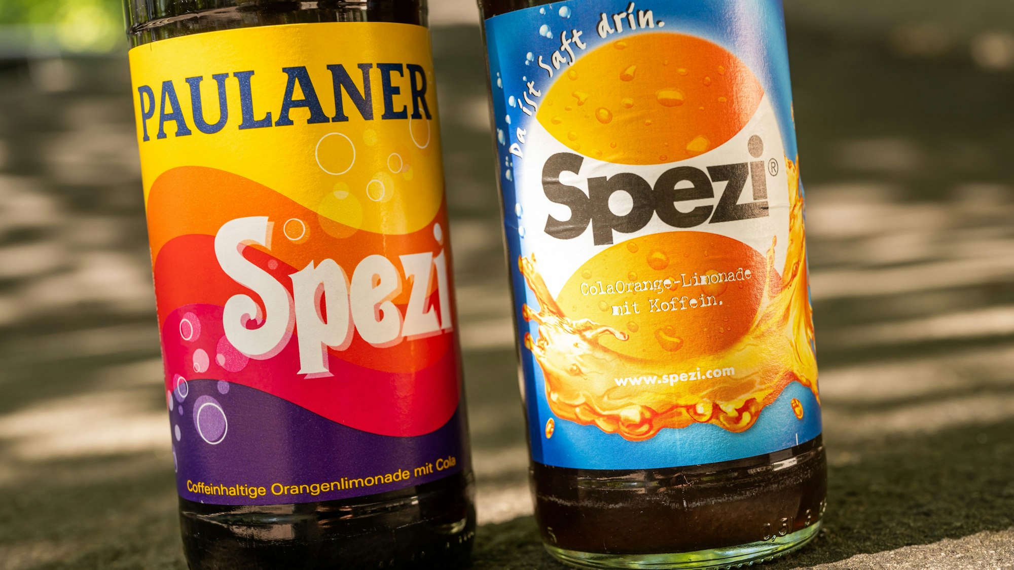 Eine Flasche des Kultgetränks ‚Spezi‘ (links) von der Großbrauerei Paulaner und eine Flasche ‚Spezi‘ der Augsburger Riegele Brauerei.