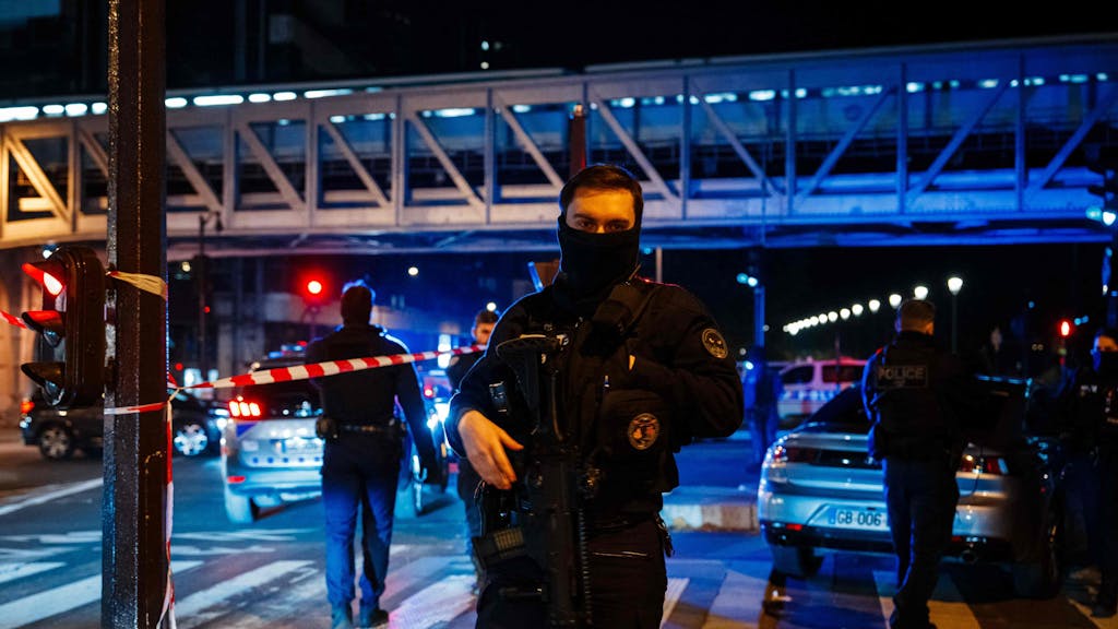 Ein Polizeibeamter steht am Tatort Wache nachdem ein mutmaßlicher Islamist unweit des Eiffelturms am Samstagabend (2. Dezember 2023) einen deutschen Touristen mit einem Messer getötet hat.