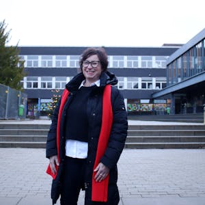 Alexandra Kühne, stellvertretende Vorsitzende der Schulpflegschaft, steht lächelnd auf dem Schulhof des St.-Angela-Gymnasiums.