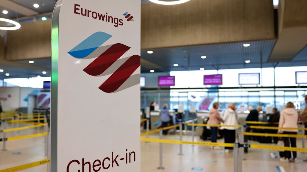Reisende am Flughafen Köln/Bonn stehen in der Abflughalle an den Check-in-Schaltern der Airline Eurowings, hier im Oktober 2022.&nbsp;