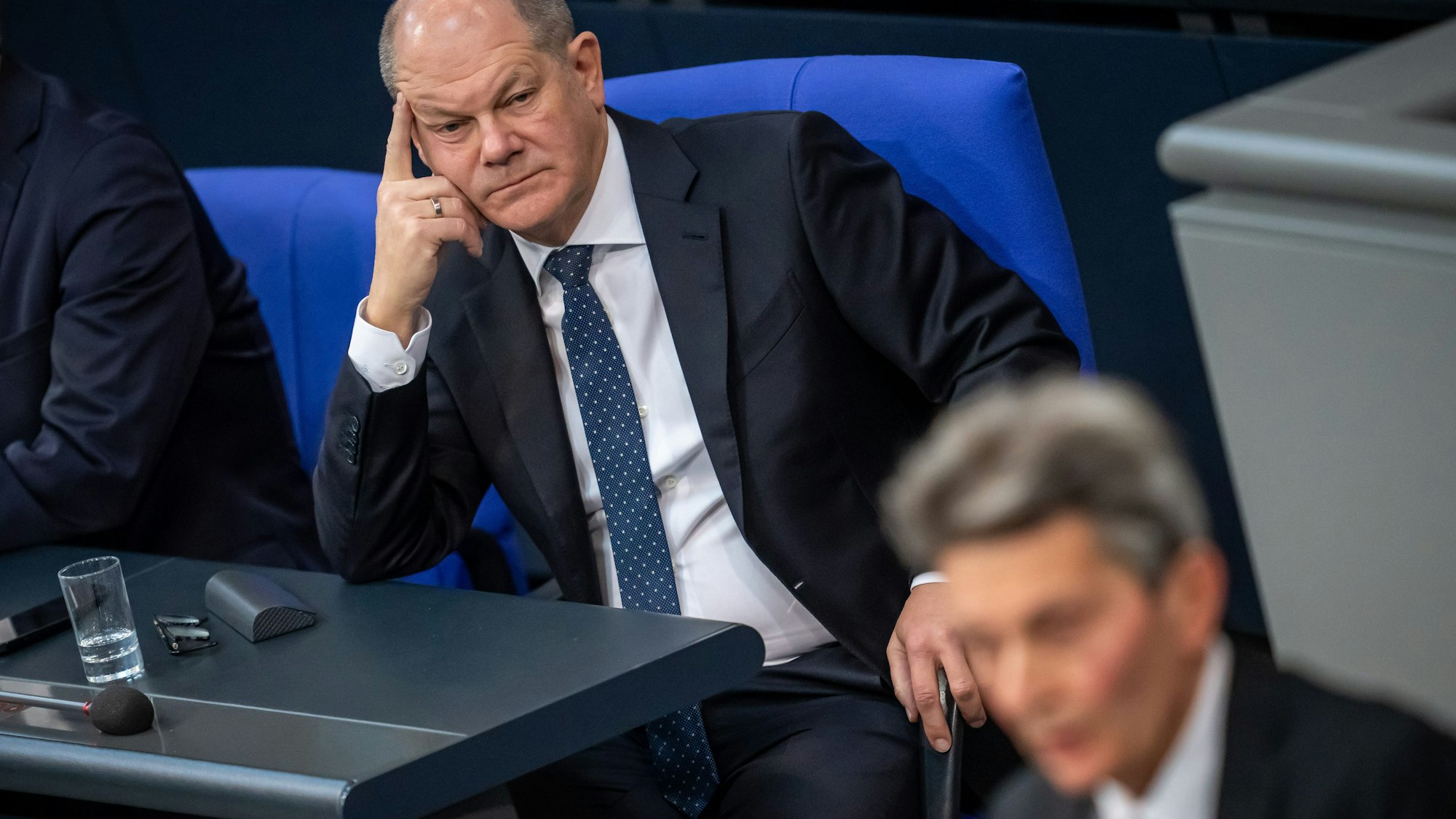 Bundeskanzler Olaf Scholz (SPD, l) verfolgt eine Rede von Rolf Mützenich im Bundestag.