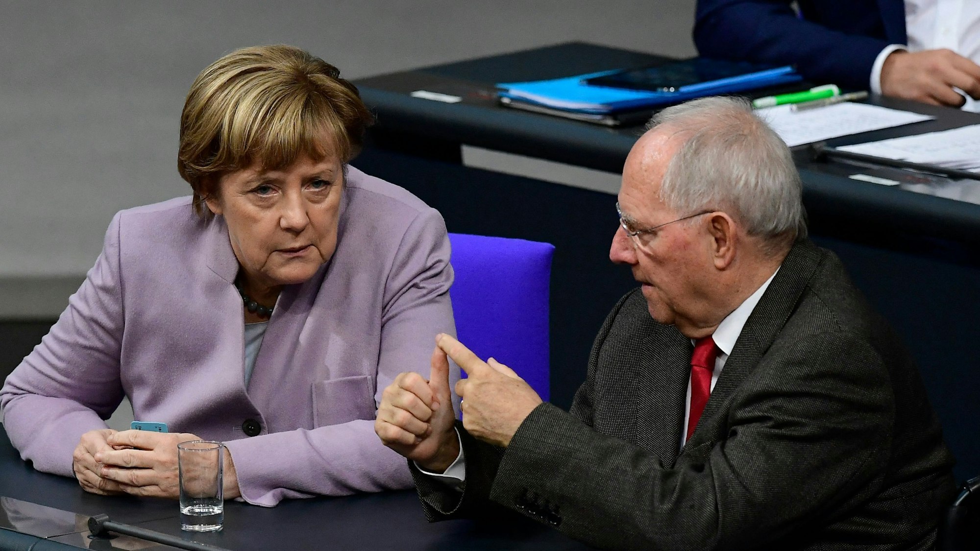 Die damalige Bundeskanzlerin Angela Merkel spricht mit dem damaligen Bundesfinanzminister Wolfgang Schäuble während einer Sitzung des Bundestages in Berlin am 25. November 2016, während einer Woche der Haushaltsdebatte.