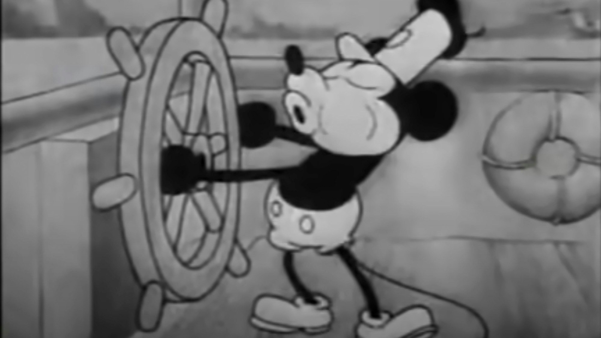 This still image from video provided by Disney shows the character Mickey Mouse in the 1928 animated short "Steamboat Willie." On Monday, Jan. 1, 2024, the iconic character from “Steamboat Willie” entered the public domain after the expiration of the 95-year copyright, and is already the focus of two horror films.  (Disney via AP)
