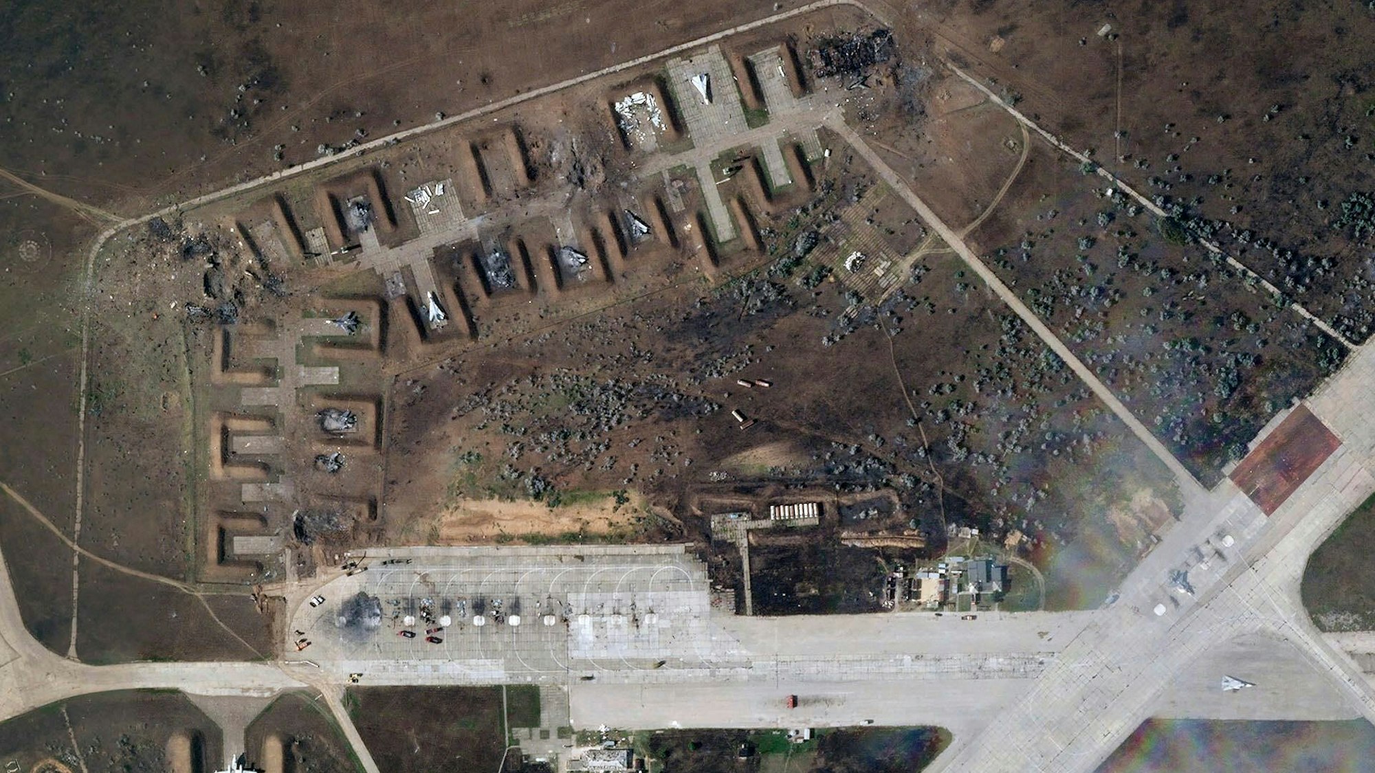 Das Satellitenbild zeigt zerstörte russische Flugzeuge auf dem Luftwaffenstützpunkt Saki nach einer Explosion im August 2022. Die Ukraine meldet nun erneut erfolgreiche Angriffe auf den russischen Militärflughafen.