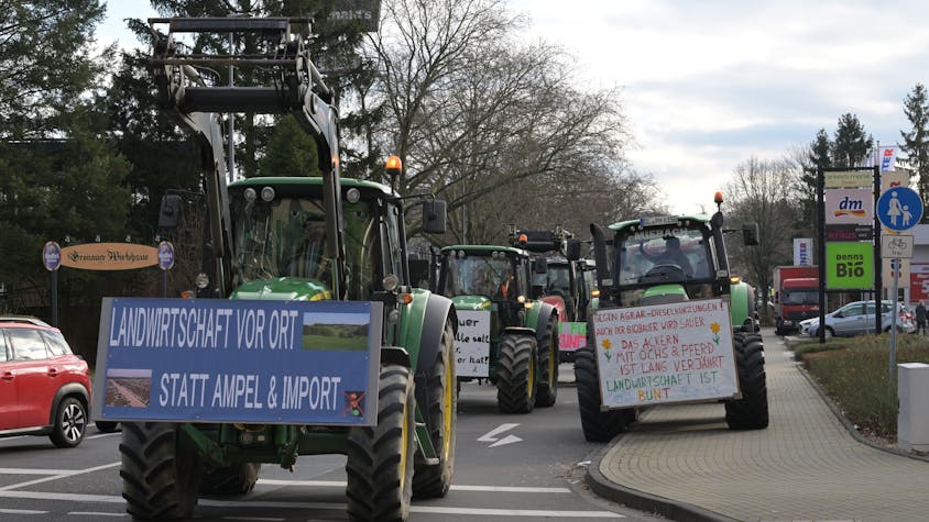 Traktoren mit Protestschildern stehen auf der Richard-Zanders-Straße in Bergisch Gladbach.