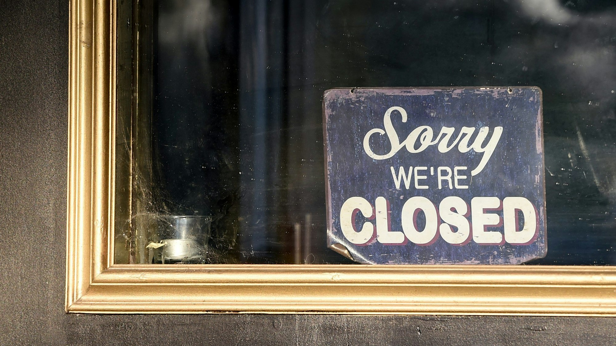 An der Tür eines geschlossenen Restaurants hängt ein Schild mit der Aufschrift „Sorry we·re closed“. (Archivbild)