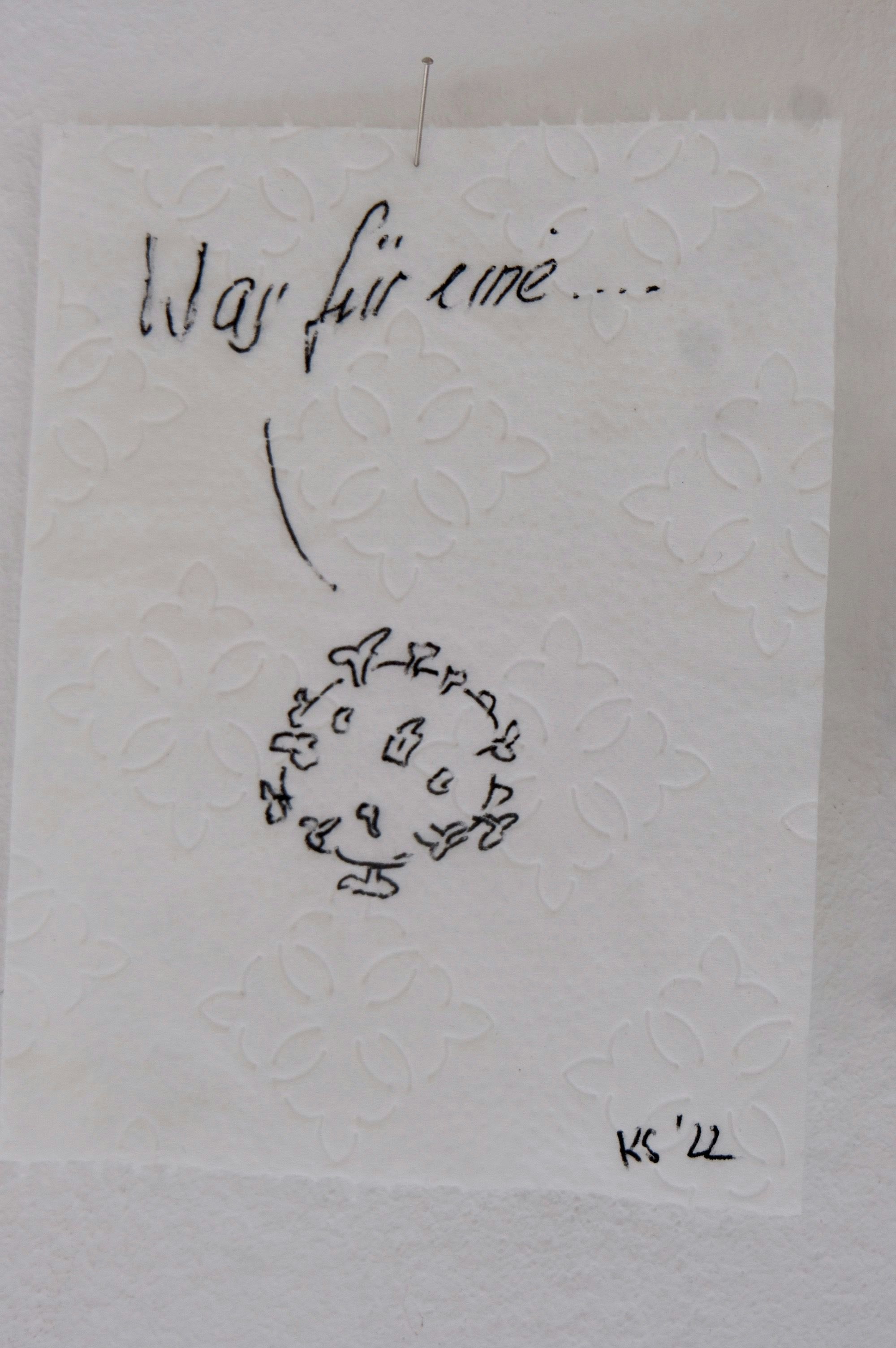 Die Zeichnung eines Coronavirus prangt auf einem Stück Toilettenpapier.