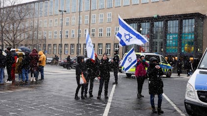 Menschen schwenken Israel-Flaggen bei einer Pro-Israel-Demo an der Universität Köln.