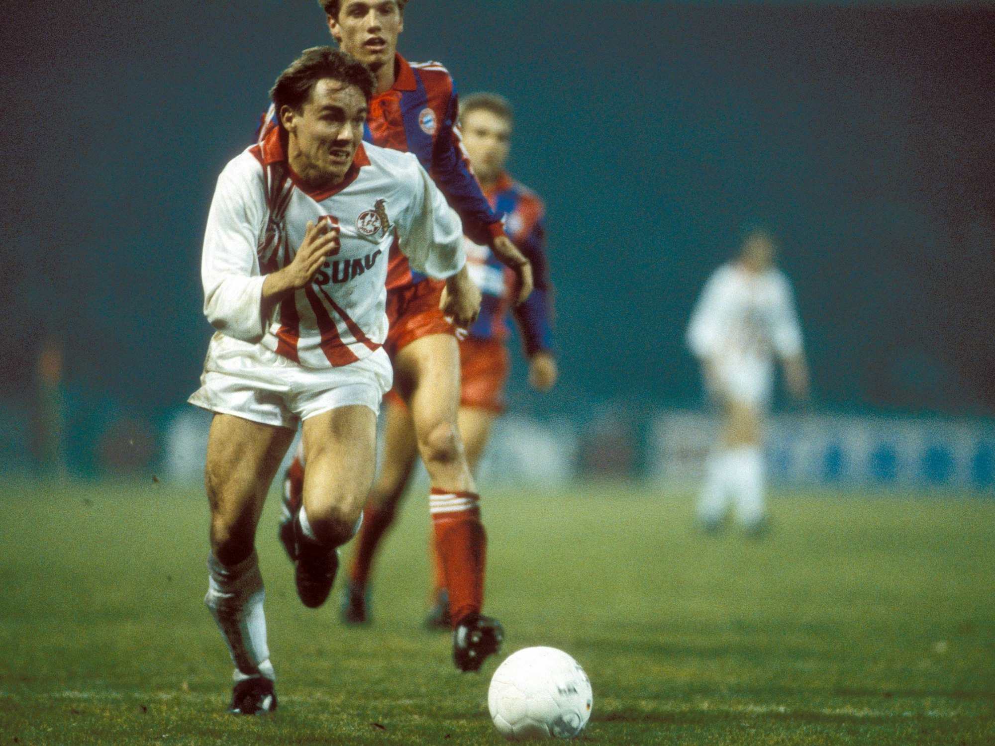 Olaf Janßen (1. FC Köln, vorne) und Thomas Strunz (FC Bayern München) auf dem Spielfeld (1990).