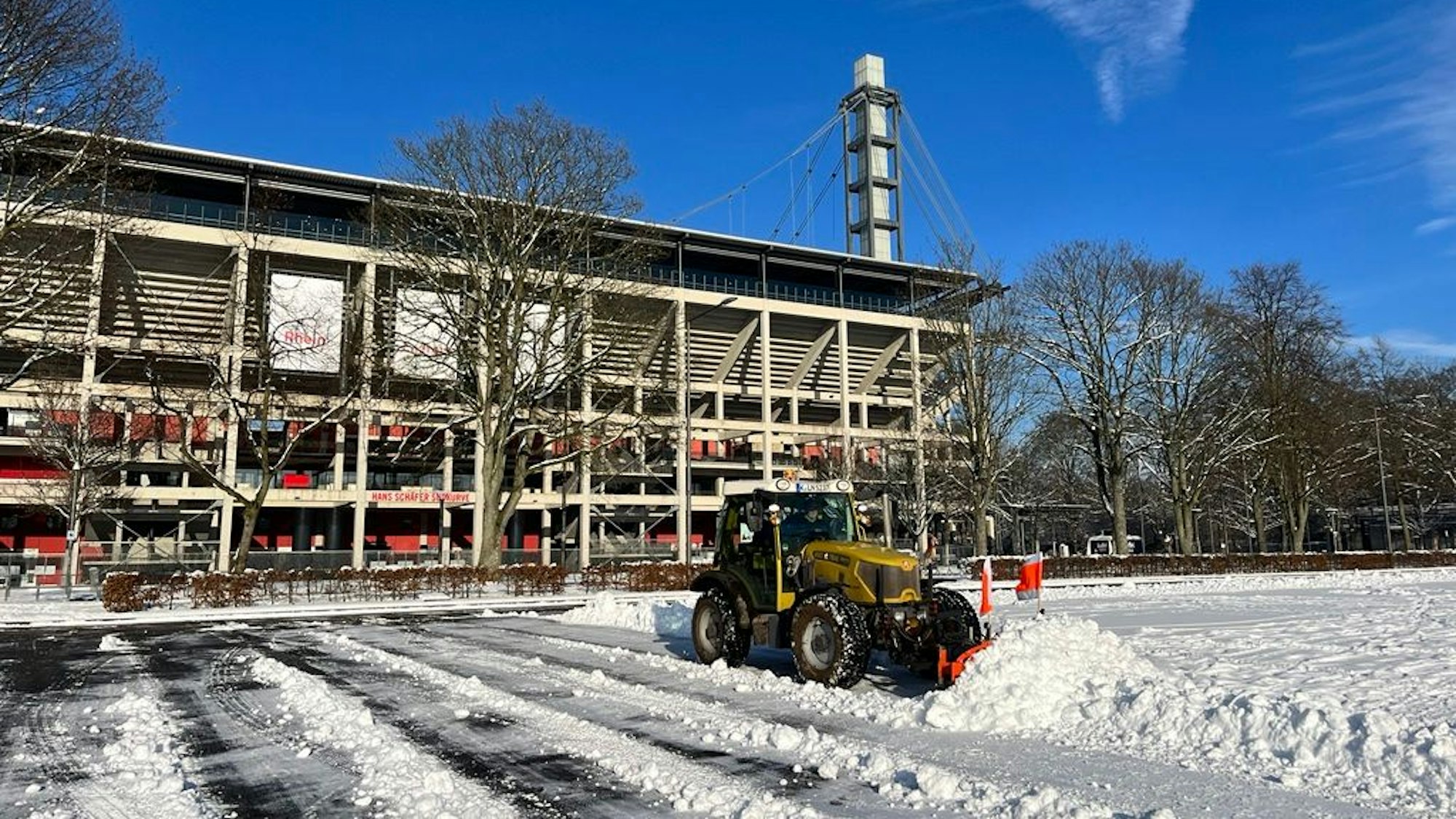 Vor dem Rhein-Energie-Stadion wird Schnee geräumt.