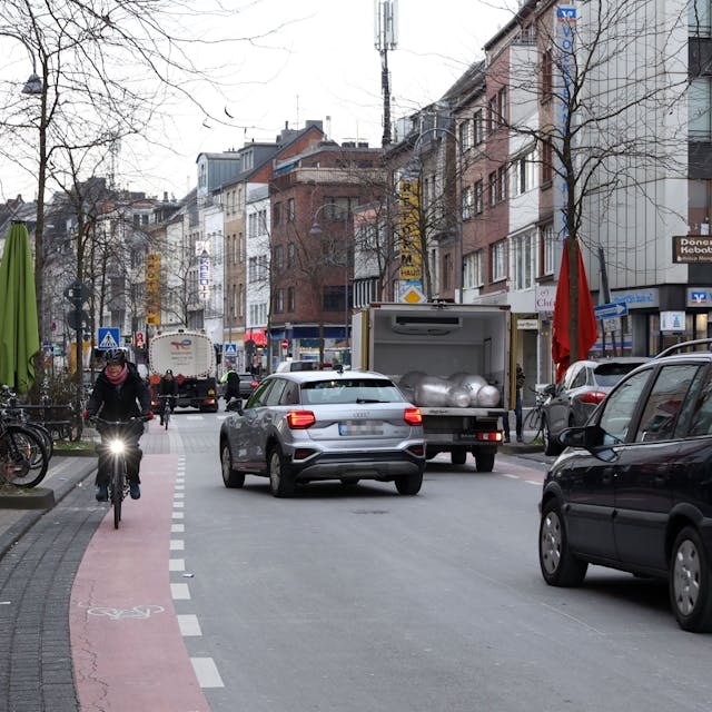Autos und eine Fahrradfahrerin fahren über die Venloer Straße.
