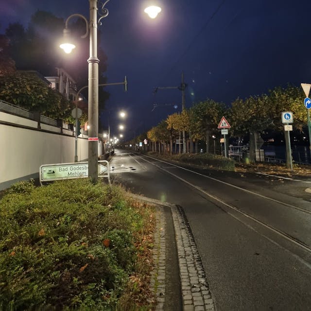 Eine Straßenlaterne in der Altstadt ist mit einem roten „Laternenring“&nbsp; markiert, das Zeichen besagt, dass die Leuchte nachts nicht durchgehend in Betrieb ist.